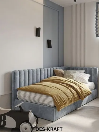 A cool and contemporary kid's room with a channel-tufted blue bed, a fun toy race car, and a two-tone wall that adds graphic interest.