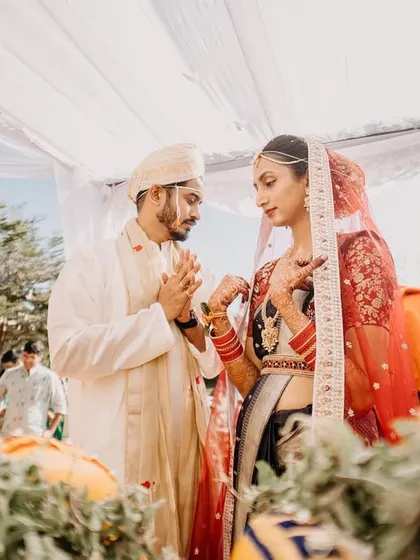 A beautiful shot of a Kannada wedding ceremony, with the couple performing rituals under a sunny sky.