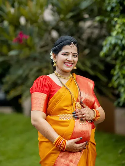 A beautiful solo portrait of the expecting mother from an outdoor shoot. Dressed in a traditional silk saree, her happiness and anticipation are radiant in the soft, natural light.