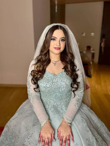A full portrait of my bride in her unique pastel gown. The makeup is designed to complement the intricate beadwork and her henna-adorned hands.