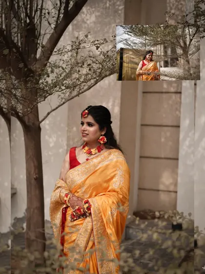 A beautiful portrait of the bride in her yellow Haldi saree, standing gracefully by a tree.