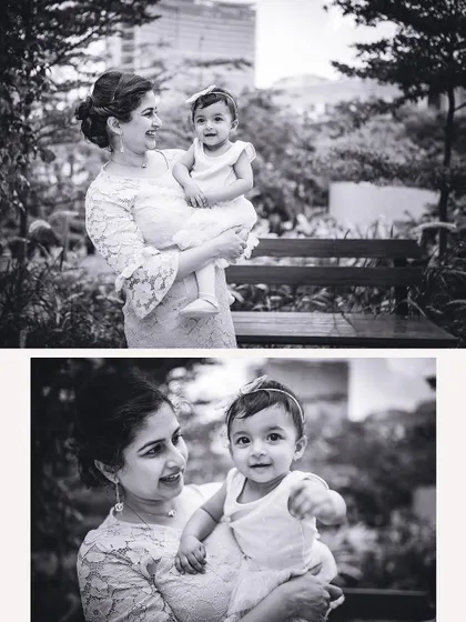 A mother and her baby girl share a sweet moment in the park. The black and white processing gives this portrait a classic, timeless quality.