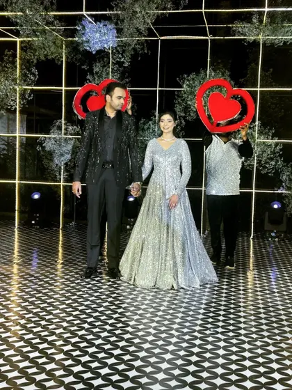 The final pose of the grand couple entry. The dancers with heart props frame the couple perfectly for a memorable photo.