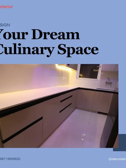 A clean, minimalist kitchen design with handleless beige cabinets and black accents. The under-cabinet lighting provides excellent task illumination while adding to the modern feel.