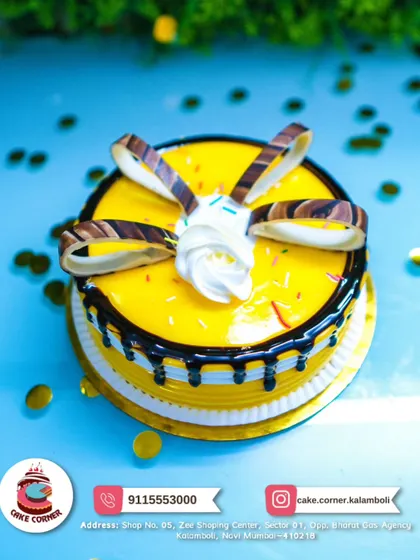 A bright and cheerful yellow cake with chocolate drip and chocolate curls. The pineapple or mango flavour is perfect for a sunny celebration.