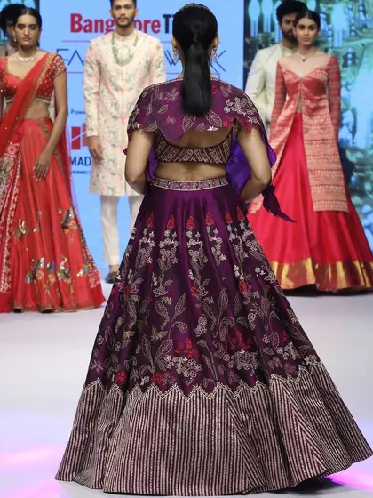 The back of this runway lehenga shows the detailed blouse and the unique cape-style organza dupatta. It’s a perfect example of how I blend traditional embroidery with contemporary silhouettes.