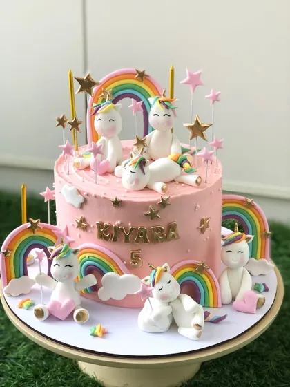 Another view of this popular unicorn and rainbow cake, showing the handcrafted unicorns playing among the stars.