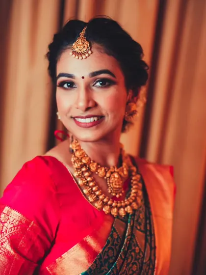 A classic bridal portrait, with the bride looking directly at the camera with a warm and happy smile.