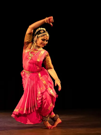 Meera Krishna in a vibrant pink costume, her movements fluid and expressive. Each performance is a story, and she tells it beautifully.