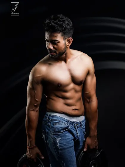 A simple but effective shot using two weight plates. Holding the weights engages the muscles in the arms and shoulders, showing practical strength in a controlled studio environment.