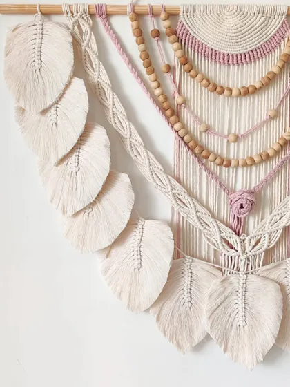 The details in this piece, from the central knot to the beaded strands, are what make it so special.