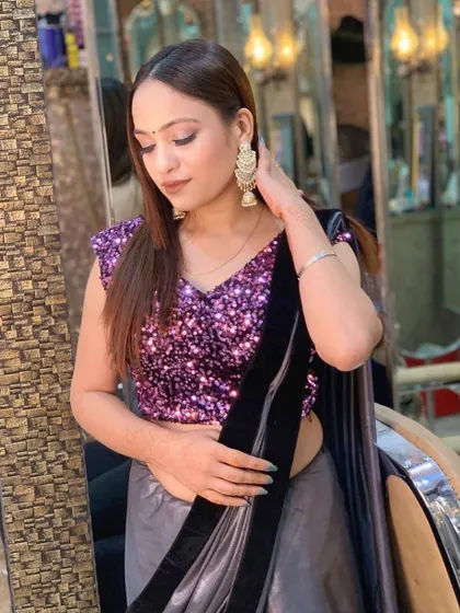 A modern party look with a sequin blouse and a satin saree. The makeup is soft and bronzed, perfect for a cocktail party or evening event.