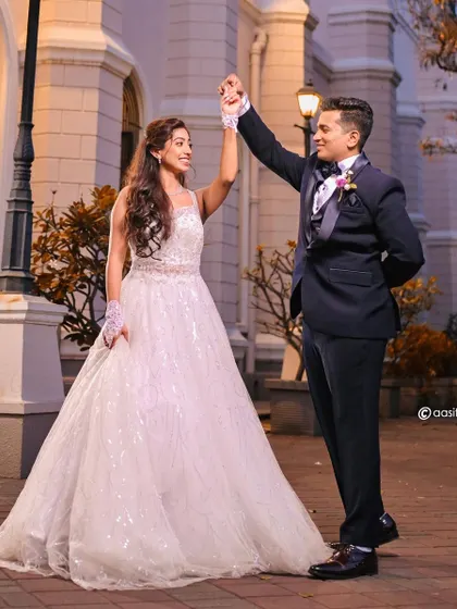 A dance to celebrate their love. This couple looks picture-perfect, with the bride in a sparkling white ball gown, ready for their church ceremony.