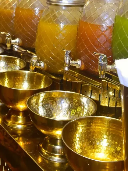 A close-up of the golgappa water dispensers and brass bowls at our chaat station. We use high-quality brassware to enhance the presentation and provide a luxurious feel.