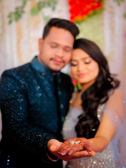 A creative shot focusing on the engagement ring in the bride-to-be's hand.
