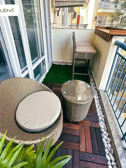 Coordinating furniture is key to a striking balcony. This set of images shows a project where we used matching wicker furniture, including a sofa, chair, table, and bar stools, to create a cohesive and stylish look.