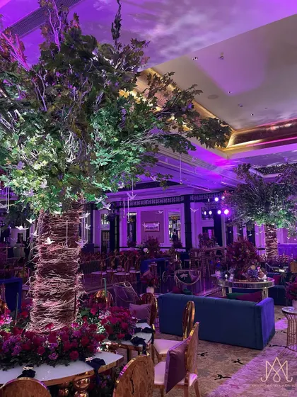 A jaw-dropping centerpiece for the sangeet night: a massive, custom-built tree installation that brings the outdoors in and creates a magical, enchanted forest feel.