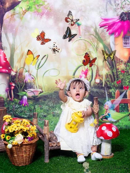 A moment of pure wonder as a baby girl in a fairy costume reaches for magical butterflies. This photo captures the innocence and imagination of childhood perfectly.