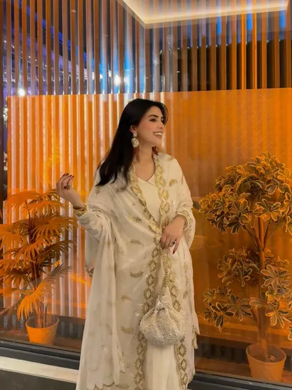 A happy, candid moment in the beautiful white and gold Anarkali.