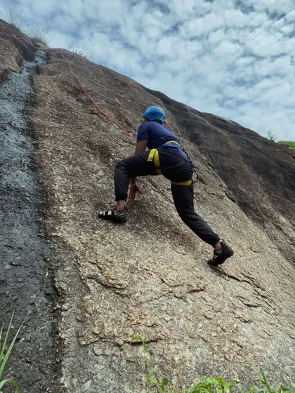 A climber practices their technique on a low-angle slab, perfect for beginners.