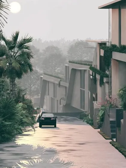 A view of the Moira Homes development, showing how the structures are nestled into the sloping terrain. The angled forms and earthy materials help the buildings merge with the wet, tropical landscape of Goa.
