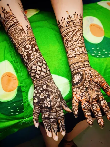 A full-arm engagement mehandi design with dense, detailed patterns. The mix of florals and jaali work creates a classic bridal look.