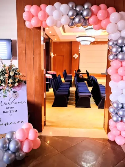 The entrance to the Baptism party, with a matching balloon arch and welcome sign.