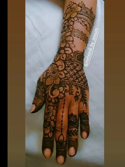 The same fusion design shown from a slightly different angle to highlight the intricate details and the flow of the pattern from the arm to the hand.