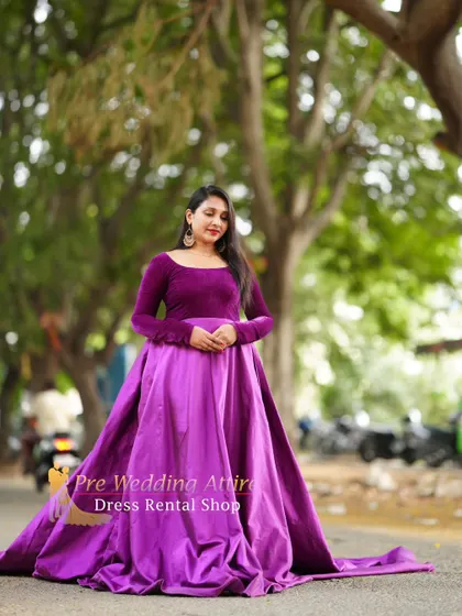 A two-tone purple gown with a velvet long-sleeve top and a satin skirt with a trail. This is a sophisticated and regal option.