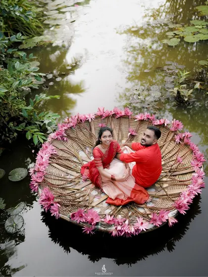 A unique aerial-style shot of the couple in a traditional coracle boat decorated with flowers, offering a breathtaking perspective.