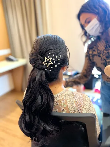 A behind-the-scenes shot of the star ponytail being styled. The accessory adds a whimsical and celestial touch.