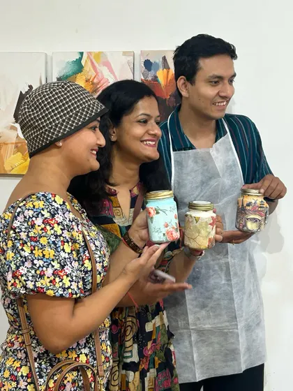 Guests at a baby shower proudly showing off the beautiful keepsake jars they decorated. It's a fun, interactive activity that leaves the parents-to-be with cherished mementos.
