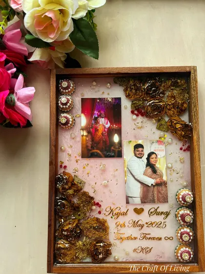 A unique design where I preserved not just the varmala flowers but also the decorative 'kalasha' elements from the wedding. This shows my ability to incorporate various meaningful items into a single frame.