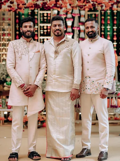 A group of dapper men from the same family, all dressed in our bespoke creations. We designed a mix of traditional dhotis and modern bandhgalas to suit each person's style.