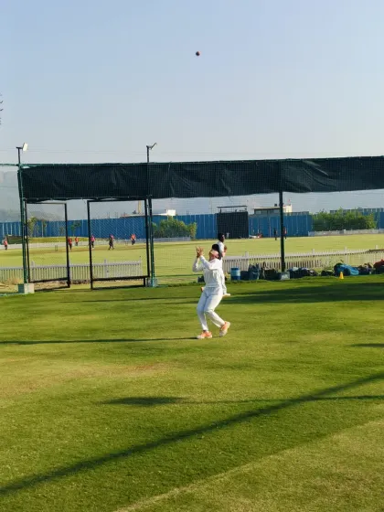 Eyes on the ball. A young cricketer positions himself perfectly under a high ball during a catching drill, demonstrating the focus and technique we instill in our players.