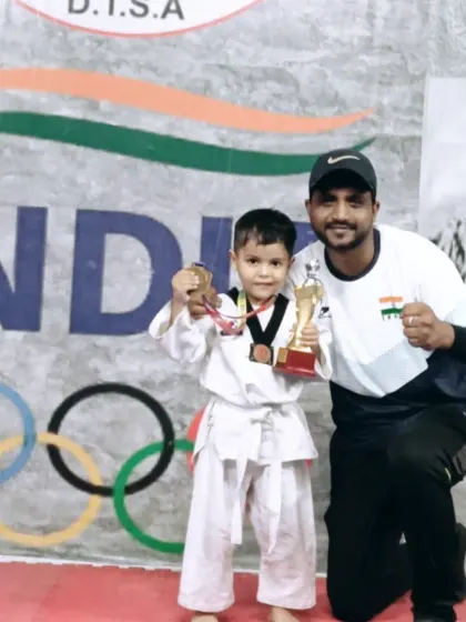 The smile of a champion. This little fighter from my academy is thrilled with his medal and trophy after a great performance.