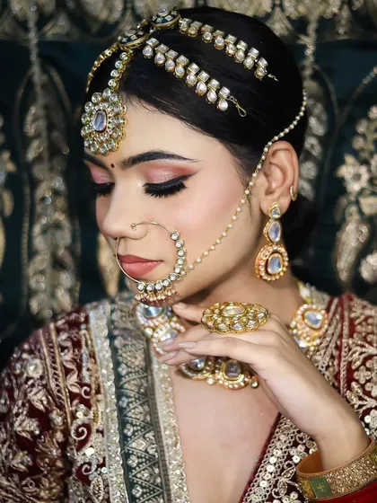 A close-up on the side profile, showcasing the detailed matha patti and the soft contouring of the face.
