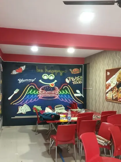 A fun and quirky mural I installed in a cafe. The chalkboard-style art and neon burger are perfect for a casual eatery.