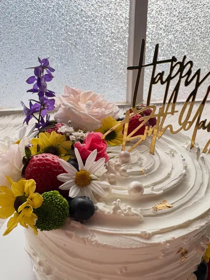 A close-up of the fresh flower and fruit arrangement. I love using a mix of strawberries, blueberries, and seasonal flowers to create texture and color.