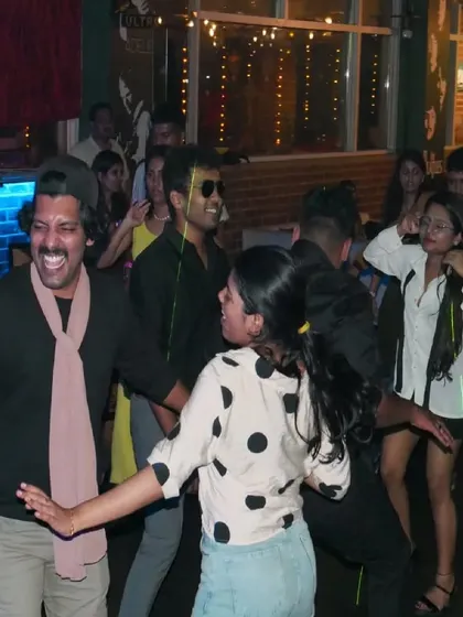 A guest in a fun costume dancing with friends. I love it when people get creative and add to the party vibe.