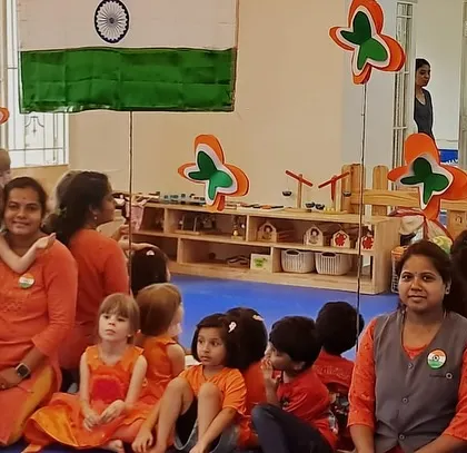 A class group photo, with everyone dressed in orange to celebrate Independence Day.