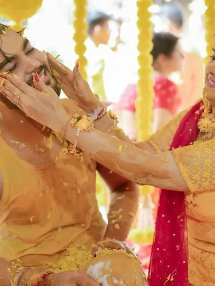 The bride playfully applying haldi to the groom. These are the candid, interactive moments that make for great memories.