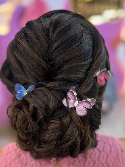 A whimsical and romantic updo with butterfly accessories. I encourage my students to get creative and develop their own unique styles.