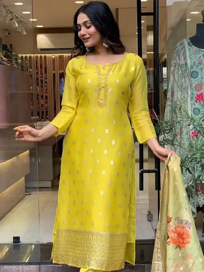 A mustard viscose organza kurta with jacquard woven details. The printed dupatta adds a modern touch to this traditional fabric.