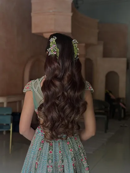 For a soft and romantic pre-wedding look, I created these beautiful, uniform waves using extensions for added length and volume. The style is finished with small, fresh floral clips, making it ideal for an engagement or Sangeet ceremony.