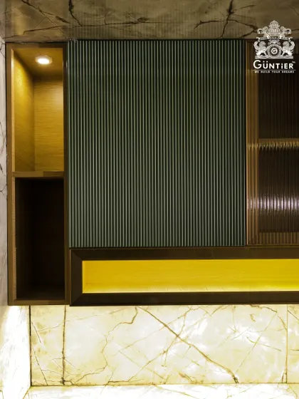 A close-up of the material combination in one of our bespoke kitchens. The contrast between the dark fluted panel, the reeded glass, and the warm wood niche creates a rich, layered look.