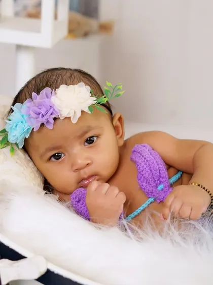 An intimate close-up portrait of the baby from the mermaid shoot. Her beautiful eyes and soft features are the main focus in this simple, sweet shot.