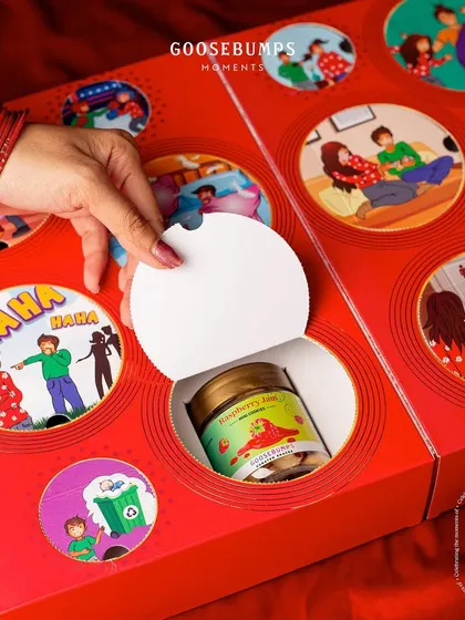 The joy is in the discovery. This image captures the moment a new treat, Raspberry Jam Mini Cookies, is found behind a playful illustration of sibling banter.