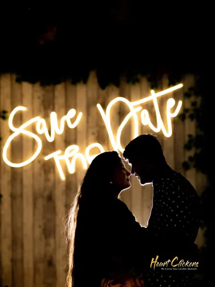 A creative "Save the Date" silhouette against a neon sign. This is a fun and modern way to announce your upcoming wedding day.