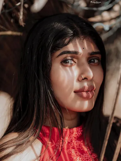 A beauty-focused shot where the shadows of the leaves highlight the model's features. This demonstrates my creative approach to using natural elements in portraits.